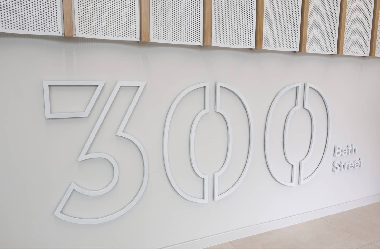 300 Bath Street wall-mounted branding, white on white.